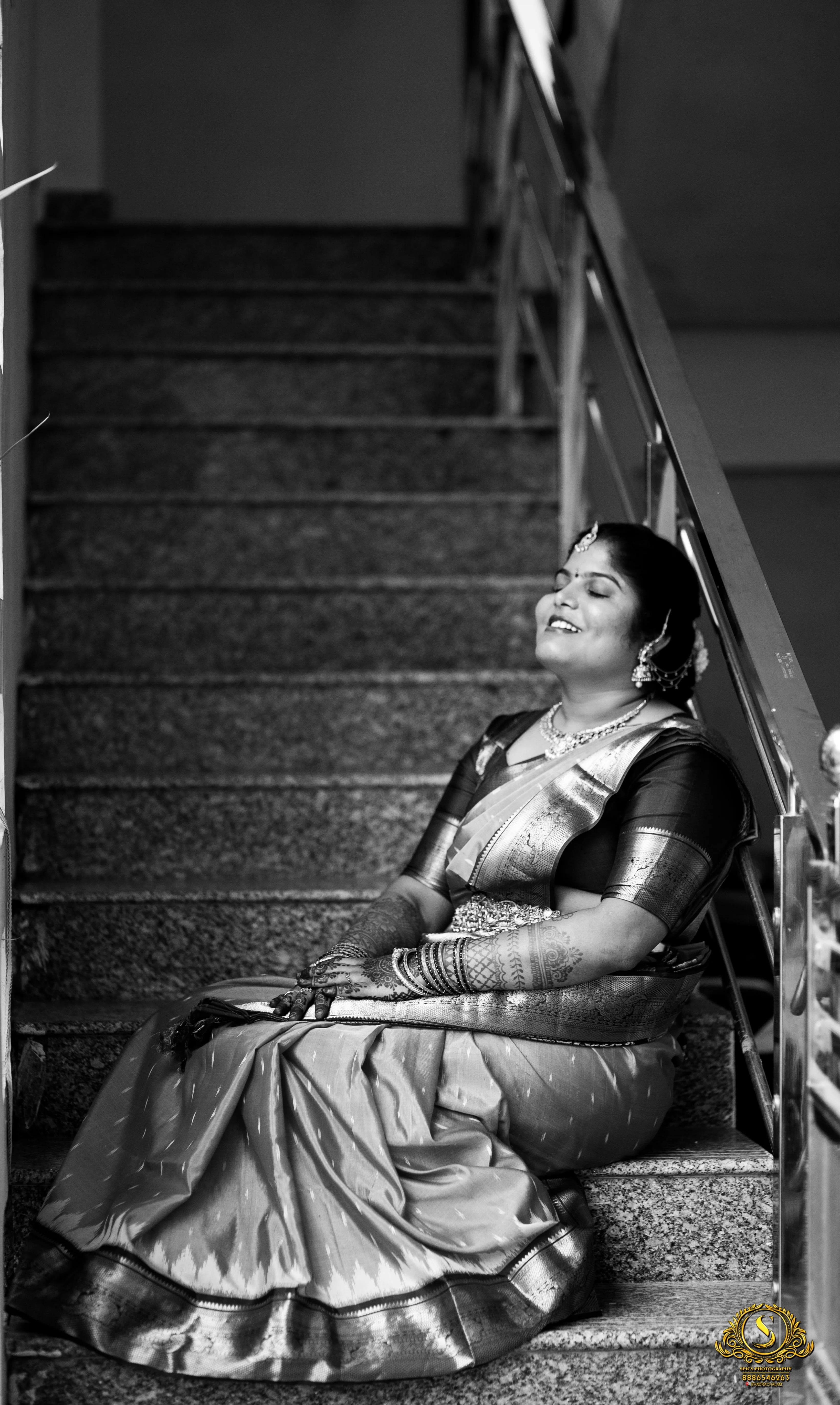 Bride in elegant bridal attire with floral backdrop