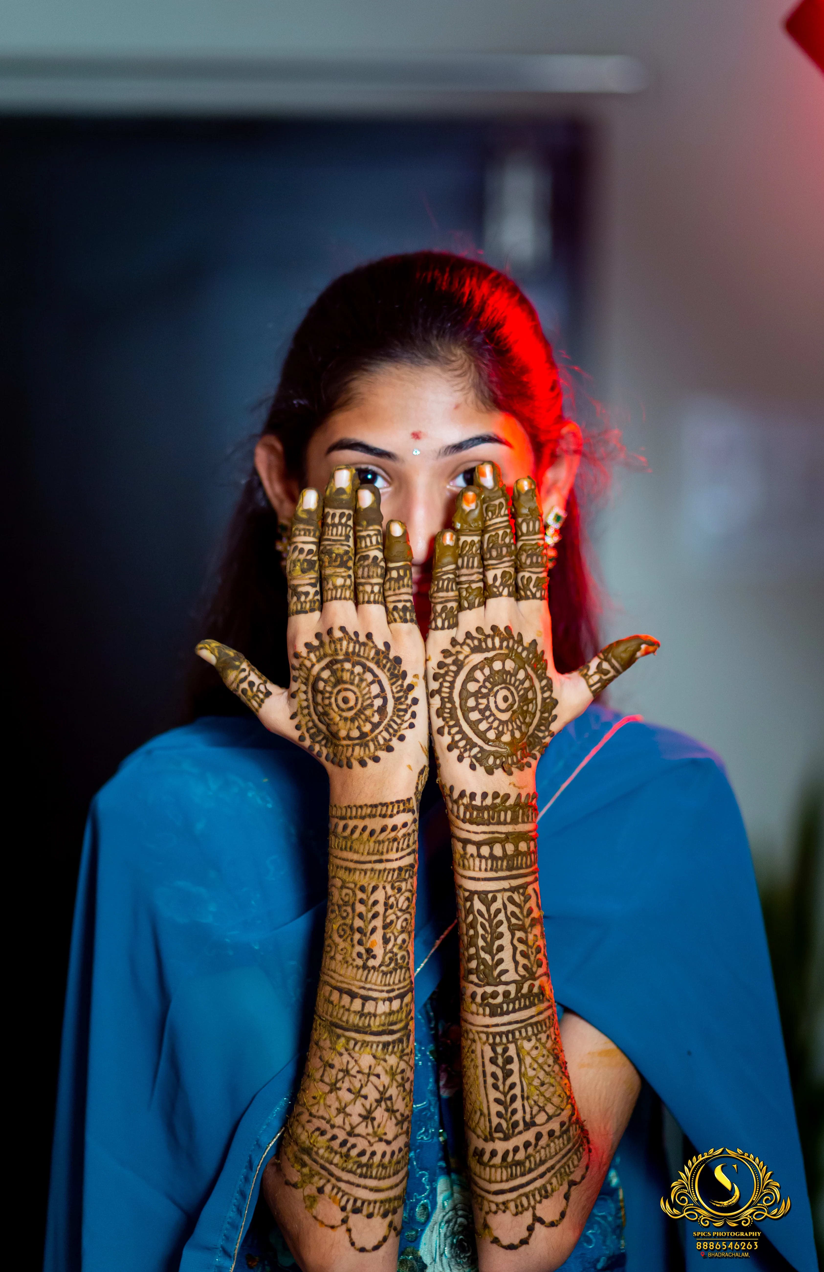 Close-up of intricate mehandi patterns on bride's hands